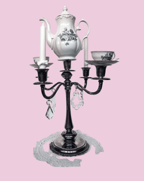 Candelabro vintage con tetera de porcelana blanca con flores verdes, tazas a juego, cristales colgantes y tapete de crochet blanco, perfecto para un estilo unicoy acogedor